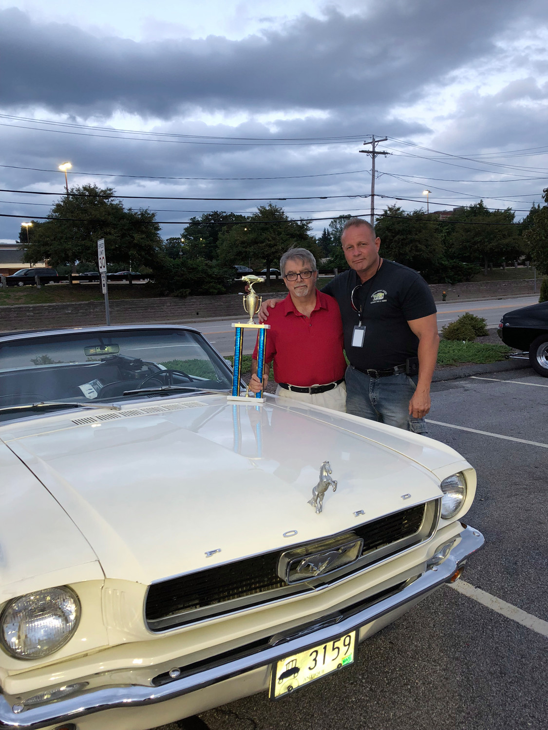 MEMORIAL MATES: Michael Pingitore (left) who brought his late father Raymond’s white 1966 Ford Mustang Convertible to last Thursday night’s Cruisin’ for as Cause, is joined by Johnston Street Machines President Gary Maddocks after accepting his winning trophy.